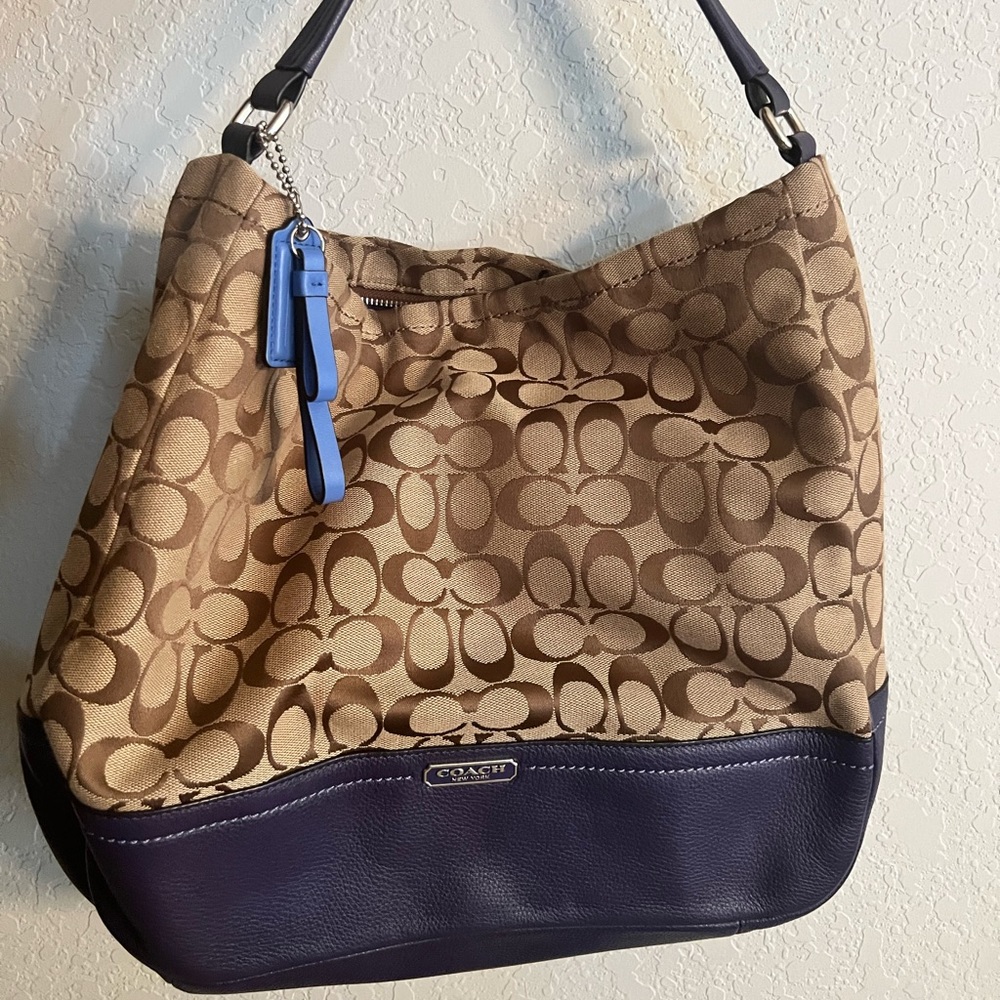 Medium size coach bag, color, tan with purple bottom and strap, purple inside